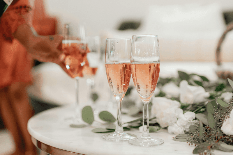 https://www.californiachampagnesabers.com/wp-content/uploads/2026/03/Glasses-of-rose-Champagne-on-a-table-with-flowers-during-a-celebration.png