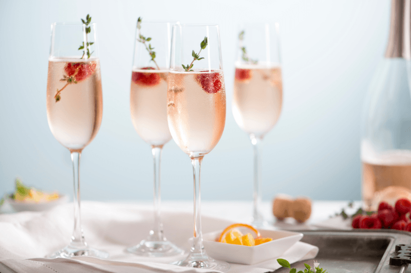 https://www.californiachampagnesabers.com/wp-content/uploads/2026/03/Rose-Champagne-served-in-flutes-with-strawberry-garnish-and-bubbles.png