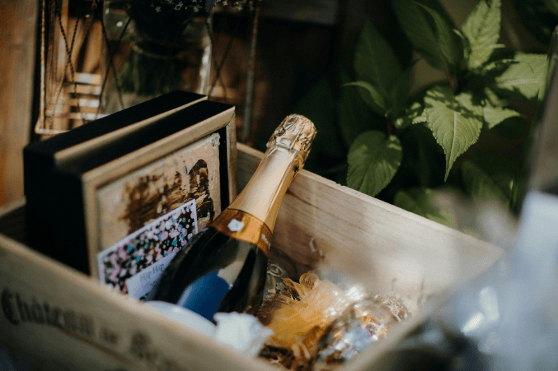 https://www.californiachampagnesabers.com/wp-content/uploads/2026/05/Champagne-bottle-presented-in-a-wooden-gift-box-with-decorative-greenery.png